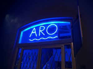 Blue glow of the ARO neon sign in South Austin